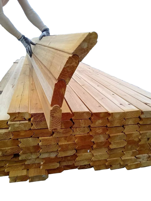 Person handling wooden planks with stacks of wood and boxes in the background